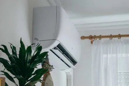 Split air conditioner on a white wall closeup 
