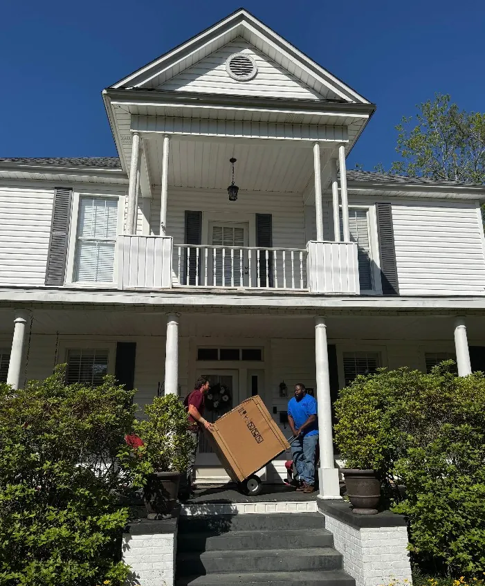 The Wingate's crew bringing a new system up the front steps of a customer's home